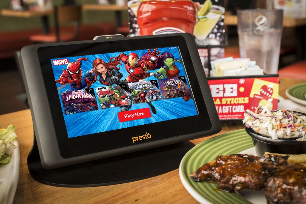 Presto tablet with Marvel games at restaurant table